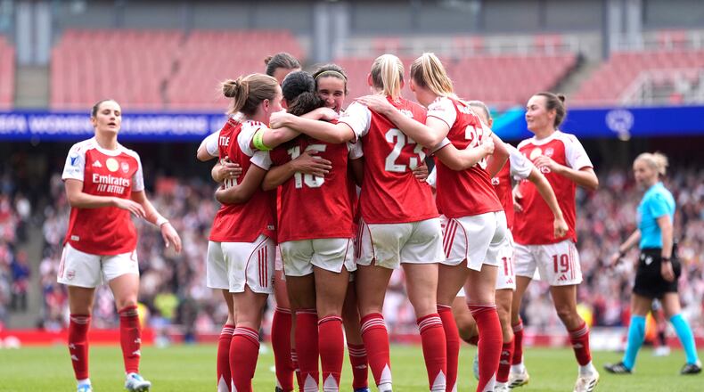 Arsenal's players celebrate their side's second goal scored by Olivia Smith during the Women's Champions League semi-final, first leg soccer match between Arsenal and OL Lyonnes in London, England, Sunday, April 26, 2026. (Andrew Matthews/PA via AP)