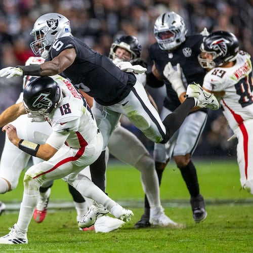 Atlanta Falcons quarterback Kirk Cousins taken down after a rushed pass by Las Vegas Raiders linebacker Divine Deablo during a December 2024 game at Allegiant Stadium in Las Vegas. (L.E. Baskow/Las Vegas Review-Journal/TNS)