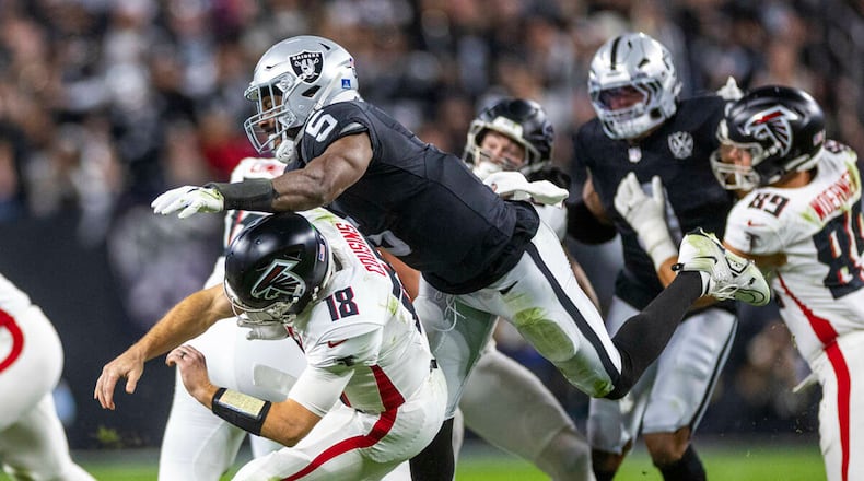Atlanta Falcons quarterback Kirk Cousins (18) is taken down after a rushed pass by Las Vegas Raiders linebacker Divine Deablo (5) during the first half of their NFL game at Allegiant Stadium on Monday, Dec. 16, 2024, in Las Vegas. (L.E. Baskow/Las Vegas Review-Journal/TNS)