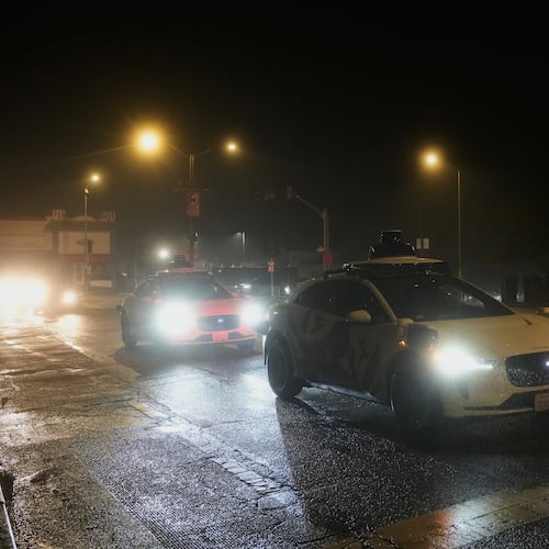 A Waymo vehicle sits idling at an intersection with no operating traffic lights due to power outages, in San Francisco, Saturday, Dec. 20, 2025. (AP Photo/Jeff Chiu)