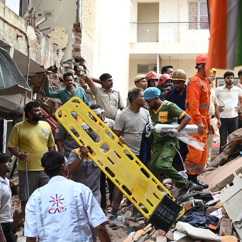 Rescue workers look for the trapped survivors under the debris of a building that collapsed in New Delhi, India, Sunday, Sept. 6, 2026. (AP Photo/ Vipin)