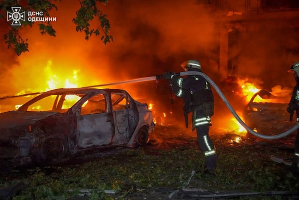 In this photo provided by the Ukrainian Emergency Service, emergency services personnel work to extinguish a fire following a Russian attack in Odesa, Ukraine, Tuesday, July 22, 2025. (Ukrainian Emergency Service via AP)