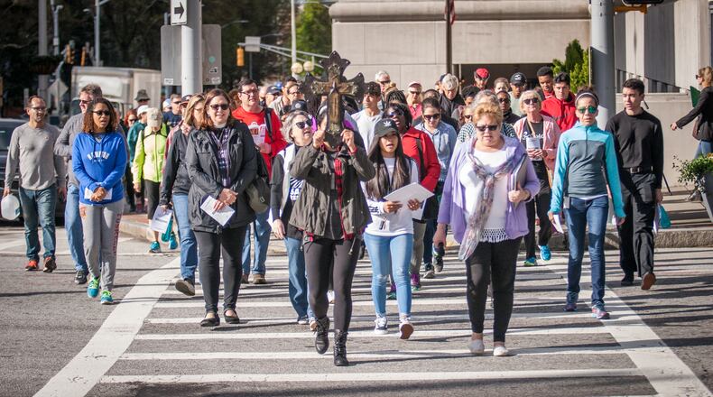 Justice and Peace Ministries sponsored the Urban Way of the Cross last year with dozens of pilgrims praying at various city sites to focus on serving others in imitation of Christ. CONTRIBUTED BY THOMAS SPINK / GEORGIA BULLETIN