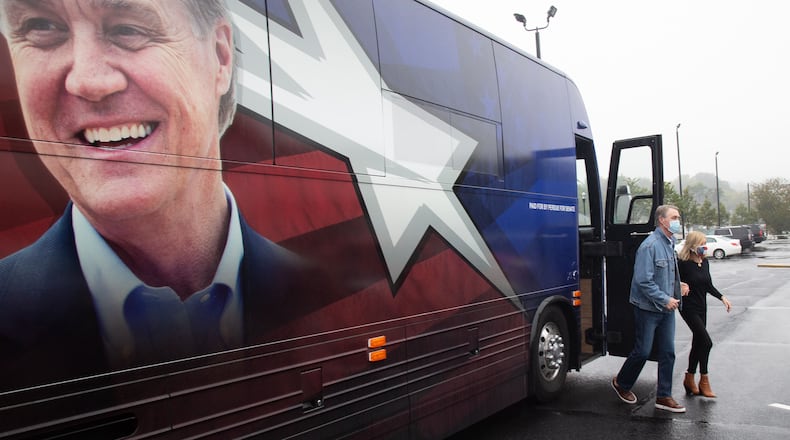 Republican U.S. Sen. David Perdue exits his bus at a campaign event Saturday in Marietta. Polling in his race against Democrat Jon Ossoff is so close, with neither candidate topping 50%, that it raises the possibility that a January runoff will be needed to settle the contest. STEVE SCHAEFER / SPECIAL TO THE AJC