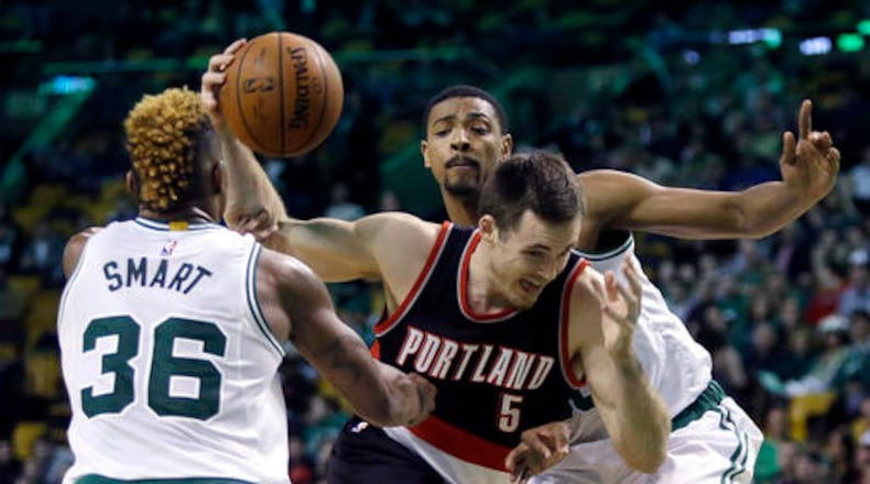Portland Trail Blazers guard Pat Connaughton (5) drives to the basket between Boston Celtics guard Marcus Smart (36) and forward Jordan Mickey, right, during the second half of an NBA basketball game Wednesday, March 2, 2016, in Boston. (AP Photo/Elise Amendola)