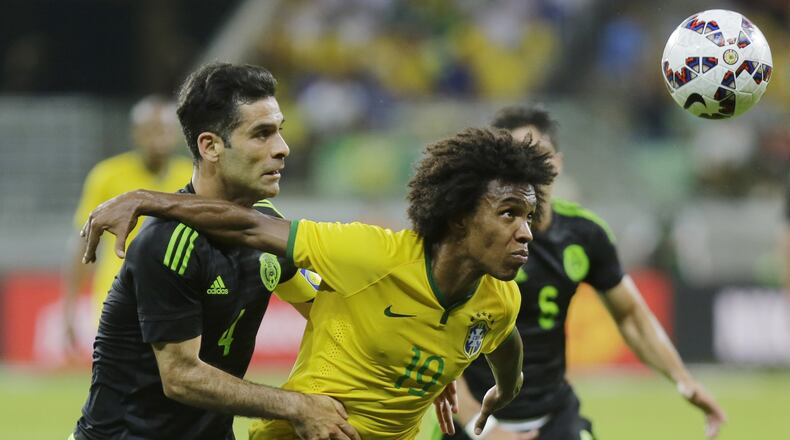 Mexico’s Rafael Marquez (left) fights for the ball with Brazil’s Willian during a friendly soccer match in Sao Paulo, Brazil, Sunday, June 7, 2015. The Mexico team will play in the Georgia Dome yet again, this time on May 28 as a warmup for the Copa American Centenario. (AP Photo/Nelson Antoine)