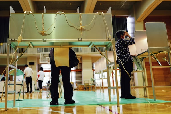 Voters fill in their ballots in the upper house election at a polling station Sunday, July 20, 2025, in Tokyo. (AP Photo/Eugene Hoshiko)