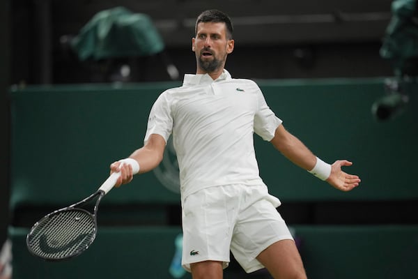 Novak Djokovic of Serbia reacts as he plays Alexandre Muller of France during their first round men's singles match at the Wimbledon Tennis Championships in London, Tuesday, July 1, 2025. (AP Photo/Kin Cheung)