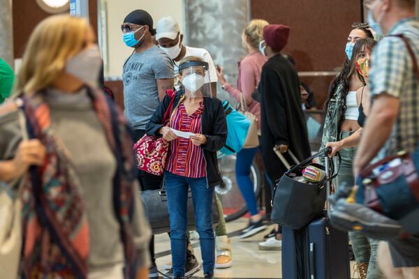 09/04/2020 -Atlanta, Georgia - A woman wearing a face shield and a face mask arrives from her flight into the domestic terminal at Hartsfield-Jackson Atlanta International Airport, Friday, September 4, 2020. (Alyssa Pointer / Alyssa.Pointer@ajc.com)