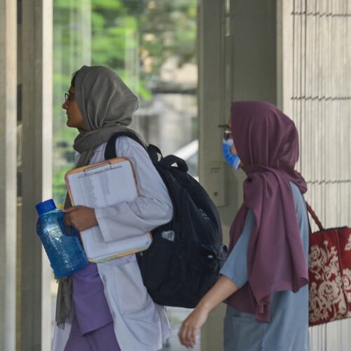 Hospital staff enter the Mother and Child Health ward at the Pakistan Institute of Medical Sciences, in Islamabad, Pakistan, Thursday, Aug. 27, 2026. (AP Photo/M.A. Sheik)