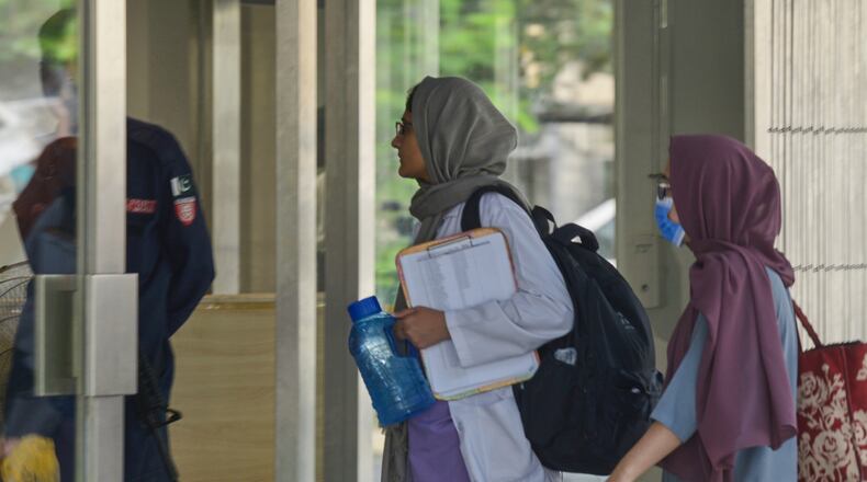 Hospital staff enter the Mother and Child Health ward at the Pakistan Institute of Medical Sciences, in Islamabad, Pakistan, Thursday, Aug. 27, 2026. (AP Photo/M.A. Sheik)