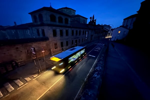 A city bus goes by the historic city of Santiago, Spain during a major power outage across Spain and Portugal Monday, April, 28, 2025. (AP Photo/Mic Smith)