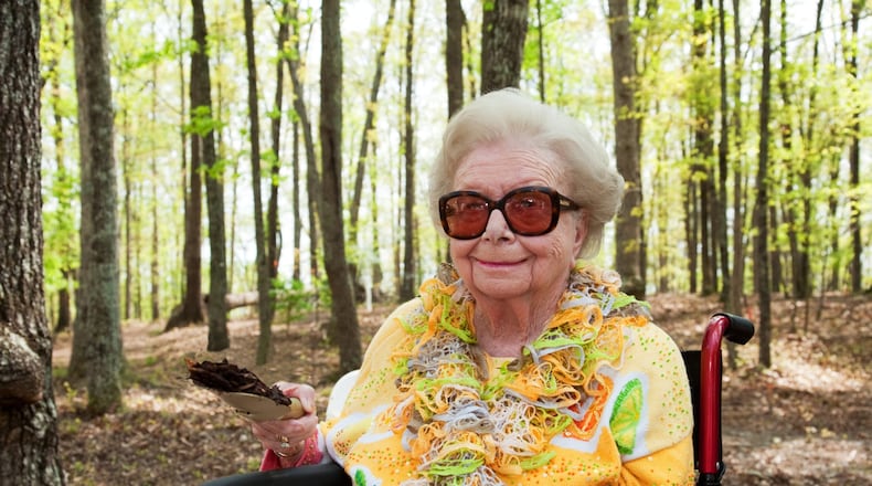 Lessie Smithgall, 102, raises a spade of dirt at Wednesday’s groundbreaking for Smithgall Woodland Garden, being created on 165 rolling Gainesville acres that she and her late husband Charles donated to the Atlanta Botanical Garden in 2002.