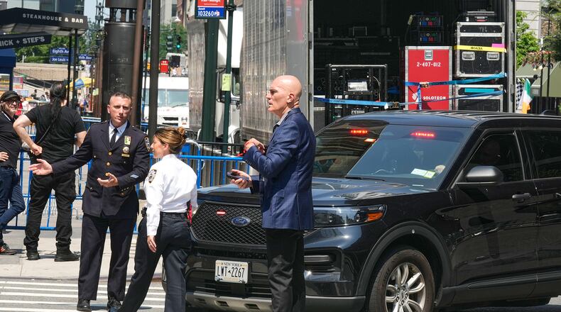 Security personnel meet outside New York's Madison Square Garden, Wednesday, July 1, 2026. (AP Photo/Richard Drew)