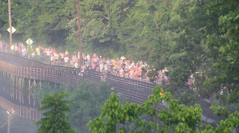 Participants race across the river in the Chattahoochee Nature Center's annual Possum Trot 10K. (Courtesy Chattahoochee Nature Center)