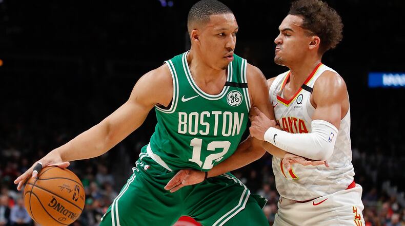 Celtics forward Grant Williams (12) drives to the basket against Hawks guard Trae Young on Monday, Feb. 3, 2020, in Atlanta. (AP Photo/Todd Kirkland)