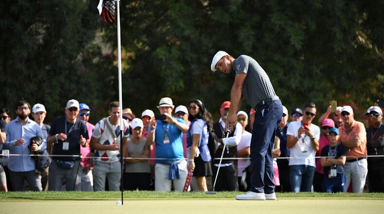 Aiming at the untended flagstick, Bryson DeChambeau works on his new putting approach earlier this year. (Photo by Ross Kinnaird/Getty Images)