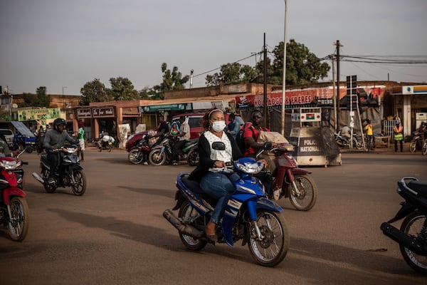FILE - People ride their scooters in the Gounghin district of Ouagadougou, Jan. 26, 2022. (AP Photo/Sophie Garcia, File)
