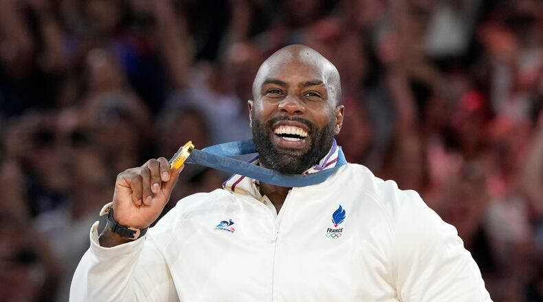 FILE - Golden medalist France's Teddy Riner poses on the podium of the judo men's +100 kg event in the team judo competition, at Champ-de-Mars Arena, during the 2024 Summer Olympics, Friday, Aug. 2, 2024, in Paris, France. (AP Photo/Eugene Hoshiko, File)