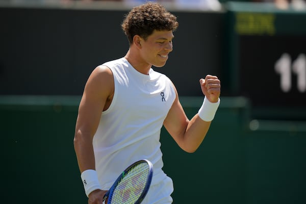 Ben Shelton of the U.S. celebrates winning the men's singles second round match against Rinky Hijikata of Australia at the Wimbledon Tennis Championships in London, Friday, July 4, 2025.(AP Photo/Alastair Grant)
