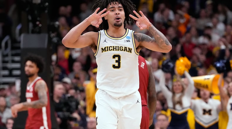 Michigan's Elliot Cadeau celebrates after making a 3-point basket during the second half in the Sweet 16 of the NCAA college basketball tournament against Alabama, Friday, March 27, 2026, in Chicago. (AP Photo/Nam Y. Huh)