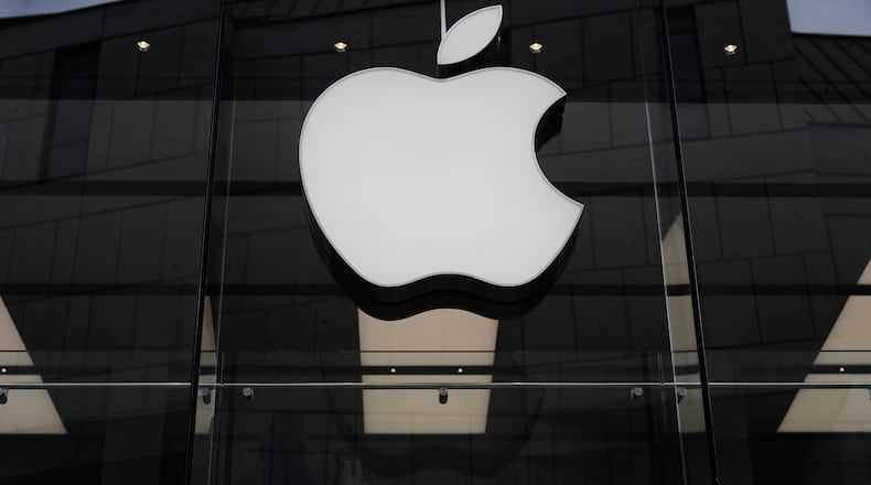 FILE - The Apple logo is illuminated at a store in Munich, Germany, April 2, 2026. (AP Photo/Matthias Schrader, File)