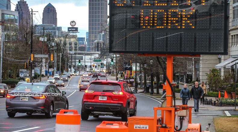 On Monday, the Georgia Department of Transportation and Georgia Power began readjusting the placement of 100 utility poles from the curb to the back of the sidewalk along the popular Midtown Road.