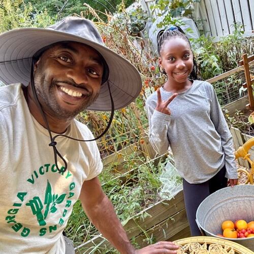 Michael McKeavin of Georgia Victory Gardens and his youngest daughter, Lauren, work in their Roswell garden. (Courtesy of Michael McKeavin)