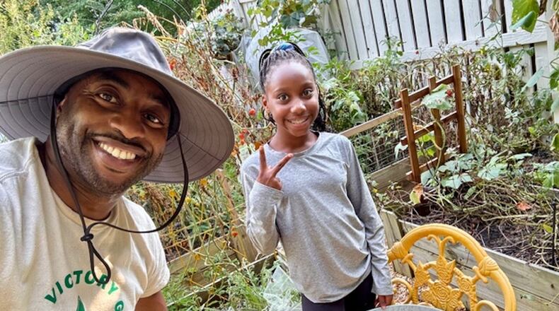 Michael McKeavin of Georgia Victory Gardens and his youngest daughter, Lauren, work in their Roswell garden. (Courtesy of Michael McKeavin)