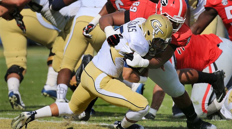 Justin Thomas is flattened on fourth-and-1. (Curtis Compton/AJC photo)