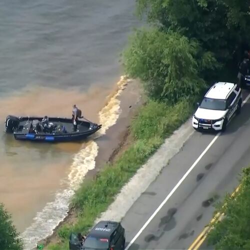This image made from video provided by WISN-TV shows law enforcement use search boats in Geneva Lake, Wis., after receiving calls of an overturned boat on Friday, July 3, 2026. (WISN-TV via AP)