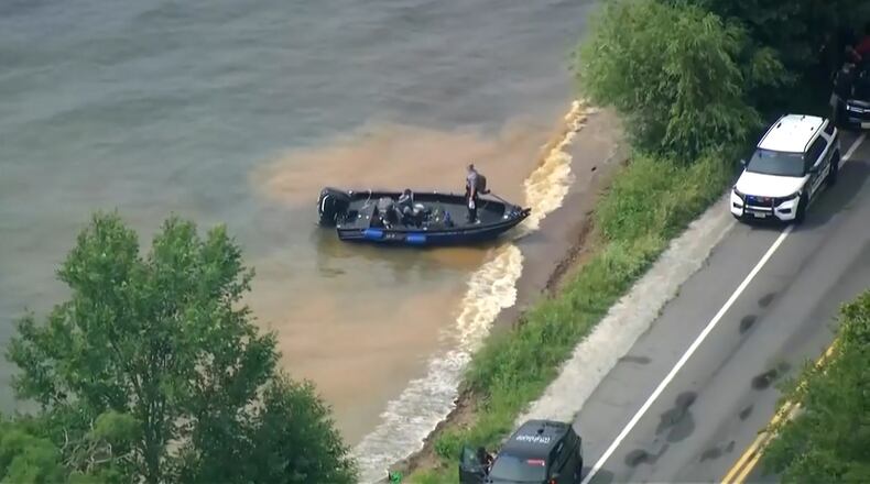 This image made from video provided by WISN-TV shows law enforcement use search boats in Geneva Lake, Wis., after receiving calls of an overturned boat on Friday, July 3, 2026. (WISN-TV via AP)