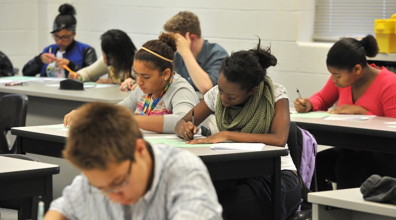 October 7, 2014 Lawrenceville - Seniors Nia Lucas, (center left), 16, and Brianna Mullin (center right), 17, take their mid-exam at AP Calculus AB class at The Gwinnett School of Math, Science & Technology on Tuesday, October 7, 2014. SAT scores released Tuesday for the nation, the state and every school. SAT scores dipped in Georgia this year, with students scoring an average of 1445 in 2014, down from last year’s average score of 1452. The overall national average for 2014 was 1497. Georgia’s mean score for critical reading was 488, math was 485 and writing was 472. This year as last year, the Gwinnett School of Mathematics Science and Technology topped the list with a score of 1912, down five points from last year. HYOSUB SHIN / HSHIN@AJC.COM