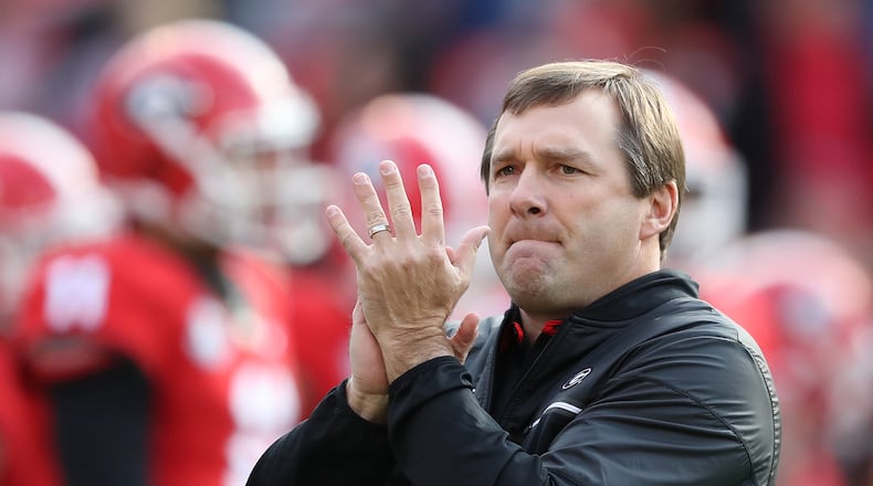 Georgia coach Kirby Smart cheers on his team as it prepares to play a game against Auburn last November. Smart went 8-5 in his first season at Georgia, including 4-4 in the SEC. (Curtis Compton/ccompton@ajc.com)