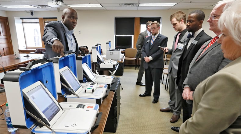 1/15/19 - Atlanta - Dwayne Broxton (left), Regional Sales Director for Hart InterCivic, demonstrates his companies' voting machines to lawmakers. Bob Andres / bandres@ajc.com