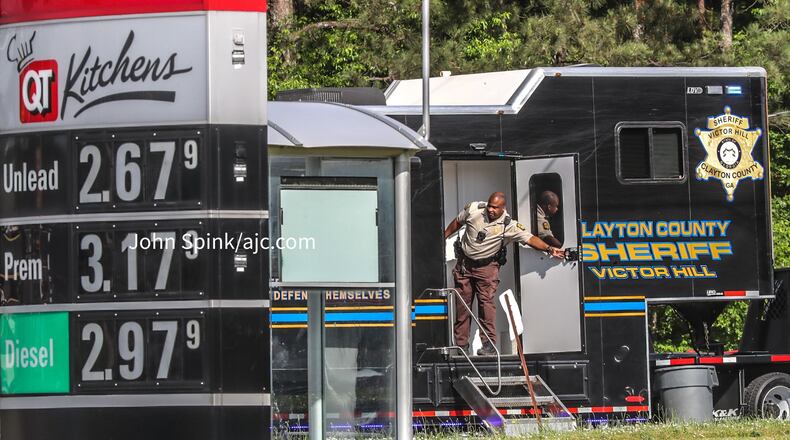 Clayton County sheriff's deputies set up a command post at the QuikTrip on Riverdale Road where an inmate escaped custody Friday morning while being transported to a state prison.