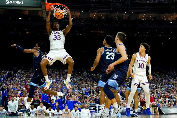 Kansas' David McCormack (33) dunks the ball against Villanova's Brandon Slater, left, defends during the second half of a college basketball game in the semifinal round of the Men's Final Four NCAA tournament, Saturday, April 2, 2022, in New Orleans. (AP Photo/Brynn Anderson)