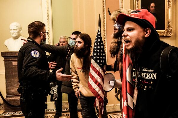 FILE -- Rioters supporting President Donald Trump confront police inside the Capitol in Washington, Jan. 6, 2021. Three months after the attack on the Capitol, the federal effort to prosecute rioters has begun shifting gears. (Erin Schaff/The New York Times)
