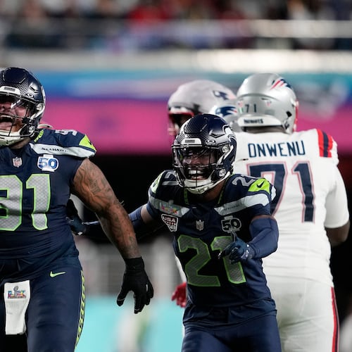 FILE - Seattle Seahawks defensive tackle Byron Murphy II (91) celebrates with cornerback Devon Witherspoon (21) after recovering a fumble by New England Patriots quarterback Drake Maye during the second half of the NFL Super Bowl 60 football game, Feb. 8, 2026, in Santa Clara, Calif. (AP Photo/Doug Benc, File)