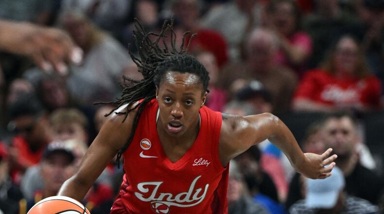 Indiana Fever guard Kelsey Mitchell (0) dribbles the ball down court during the first half of a WNBA basketball game against the Connecticut Sun, Friday, Aug. 28, 2026, in Indianapolis. (AP Photo/Marc Lebryk)