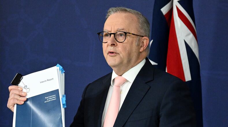 Australian Prime Minister Anthony Albanese holds up the report on Antisemitism and Social Cohesion during a press conference at the Commonwealth Parliamentary Offices in Sydney, Thursday, April 30, 2026. (Dan Himbrechts/AAP Image via AP)