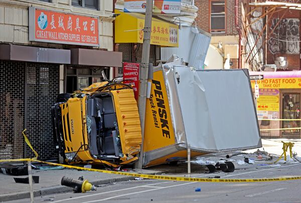 A box truck rests on a sidewalk following a crash, which injured several people in the Chinatown neighborhood of Boston on Tuesday April 1, 2025. (Matt Stone /The Boston Herald via AP)