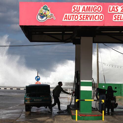 People refuel their car and motorcycle at a gas station near the Malecon in Havana, Cuba, Tuesday, Jan. 27, 2026. (AP Photo/Ramon Espinosa)