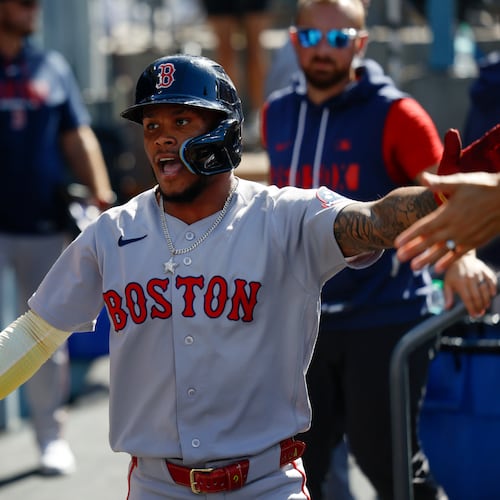 Boston Red Sox's Ceddanne Rafaela is greeted by teammates after scoring on a single hit by Sox's designated hitter Masataka Yoshida during the first inning of a baseball game, Sunday, Aug. 2, 2026, in Los Angeles. (AP Photo/Caroline Brehman)
