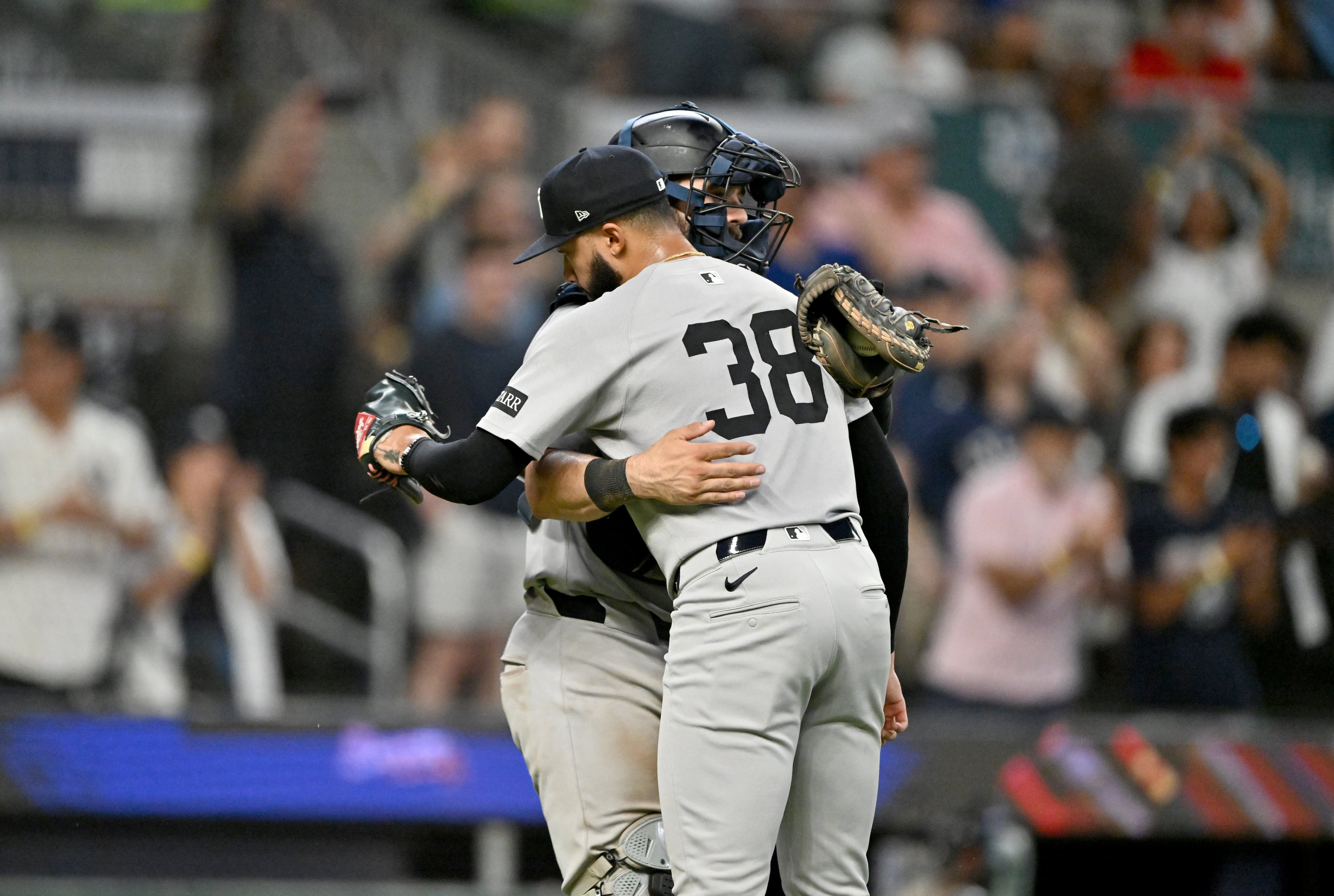New York Yankees pitcher Devin Williams (38) celebrates with New York Yankees catcher Austin Wells (28) after New York Yankees beat Atlanta Braves during a baseball game at Truist Park, Saturday, July 19, 2025, in Atlanta. New York Yankees won 12-9 over Atlanta Braves. (Hyosub Shin / AJC)