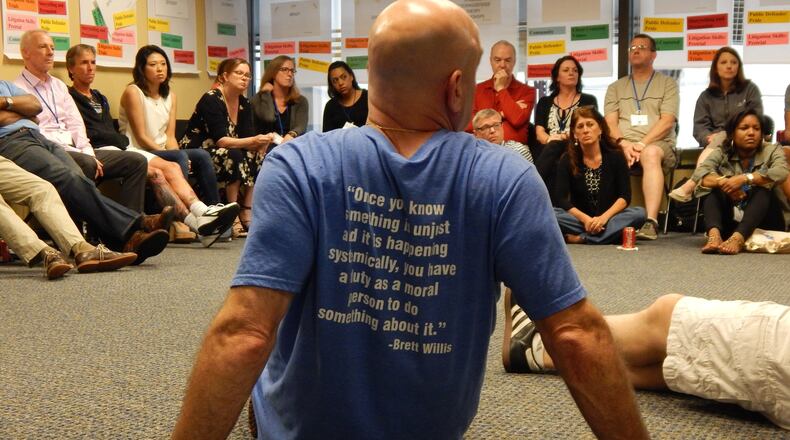 Jonathan Rapping, his back to the camera, sits with a group of public defenders and supervisors during a recent training and development session. Rapping is the founder of the non-profit Gideon’s Promise. Contributed by Gideon’s Promise
