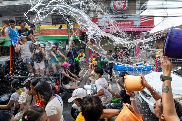People splash water during the Songkran water festival to celebrate the Thai New Year in Prachinburi Province, Thailand, Sunday, April 13, 2025. (AP Photo/Wason Wanichakorn)