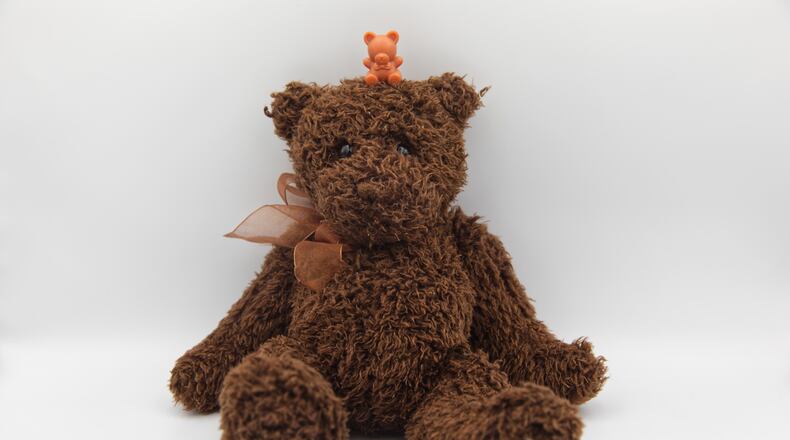 A miniature plastic teddy bear sits atop a stuffed teddy bear in Phoenix, Tuesday, April 14, 2026. (AP Photo/Dario Lopez-Mills)