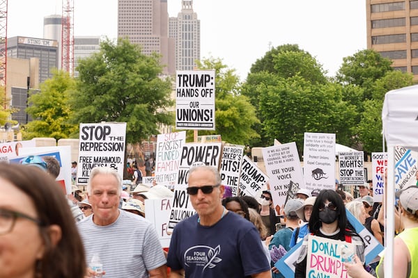 Protesters march near the Georgia State Capitol to condemn President Donald Trump's policies on International Workers' Day on Thursday, May 1, 2025. (Natrice Miller/ AJC)