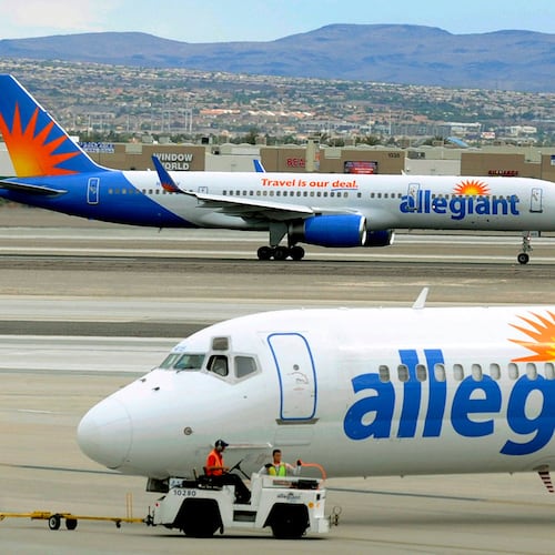 File - In this May 9, 2013, file photo, two Allegiant Air jets taxi at McCarran International Airport in Las Vegas. (AP Photo/David Becker, File)